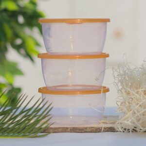 Three stacked transparent containers with orange lids on a white background.