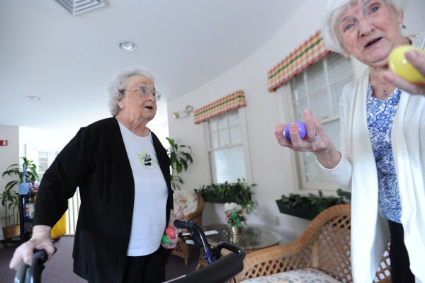 Brewer, Maine--04/15/2014--Mary Wardwell, left, and Dottie Russell, both residents at the Ellen M. Leach Memorial Home, react to finding plastic Easter eggs on the second floor during the second annual Easter Egg Hunt at the retirement home in Brewer on Tuesday. 160 eggs were hidden around the three story building, 120 containing prize numbers to be redeemed next Monday. Kevin Bennett|BDN