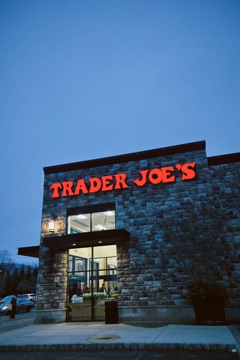 Trader joe's storefront at dusk with stone facade.