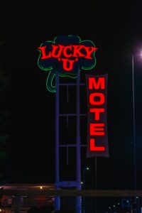 a neon sign for a motel lit up at night