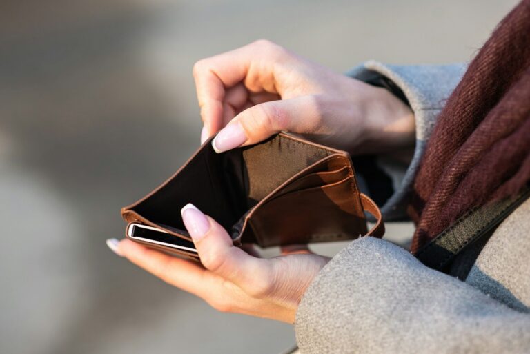 hands holding empty wallet and phone